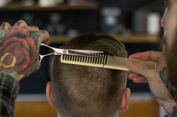 The back of a man's head as he has his hair cut
